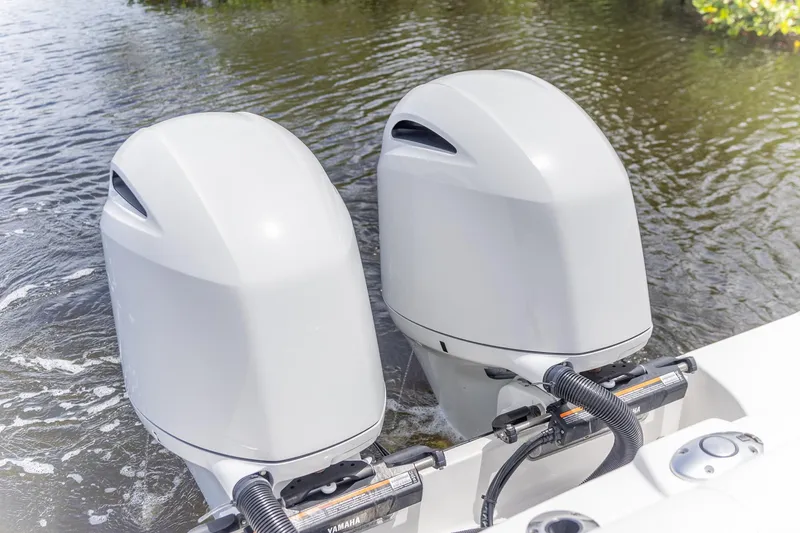 Slide: The Image of Twin outboard motors on 2023 Edgewater 262CC boat in water. - 7