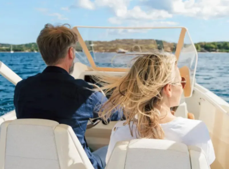 Slide: The Image of Couple enjoying a ride on a 2025 Axopar AX/E 25 boat. - 2