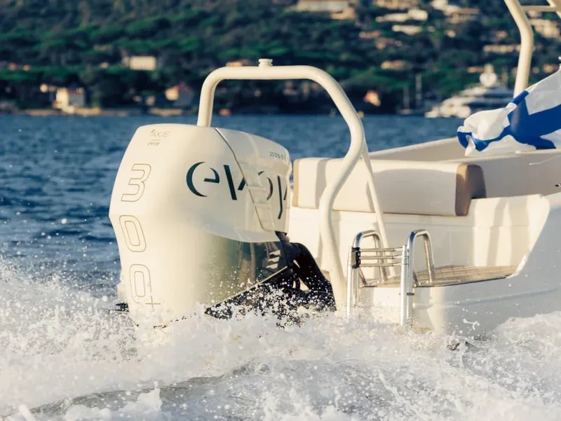 Slide: The Image of 2025 Axopar AX/E 25 boat with powerful outboard motor cruising on water. - 3