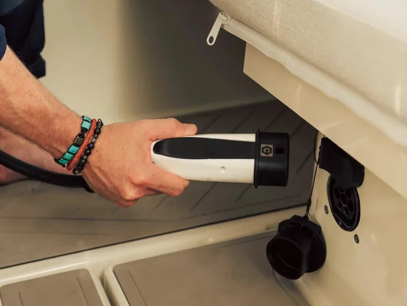 Slide: The Image of Charging an Axopar AX/E 25 boat, 2025 model, with an electric plug. - 8