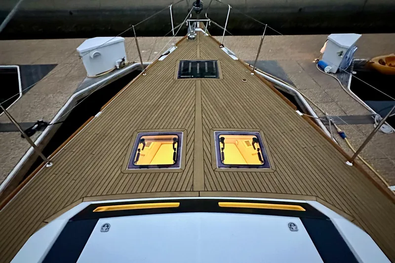 Slide: The Image of Deck view of 2021 Beneteau Oceanis 55.1 yacht with wooden finish and hatches. - 12