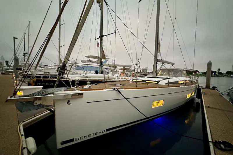 Slide: The Image of 2021 Beneteau Oceanis 55.1 yacht docked at marina during overcast evening. - 20
