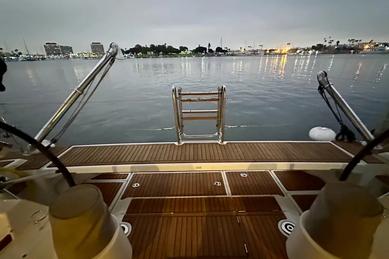 Slide: The Image of Beneteau Oceanis 55.1 yacht deck overlooking calm waters at dusk, 2021 model. - 29