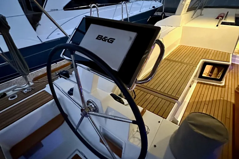 Slide: The Image of Steering wheel and navigation system on 2021 Beneteau Oceanis 55.1 yacht deck. - 31