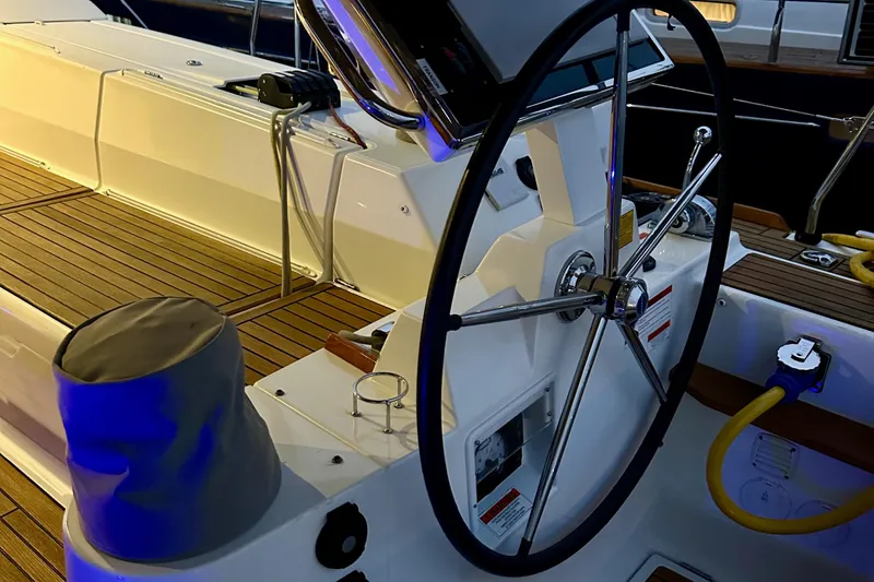 Slide: The Image of Steering wheel of a 2021 Beneteau Oceanis 55.1 yacht with teak deck. - 34