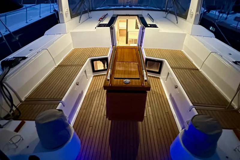 Slide: The Image of Luxurious 2021 Beneteau Oceanis 55.1 yacht deck with elegant wood finish and ambient lighting. - 37