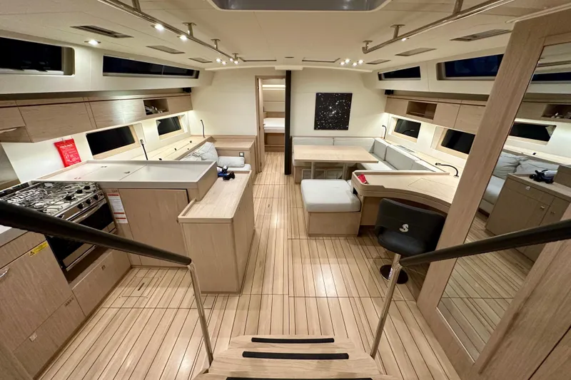 Slide: The Image of Luxurious interior of 2021 Beneteau Oceanis 55.1 yacht with modern kitchen and seating area. - 40