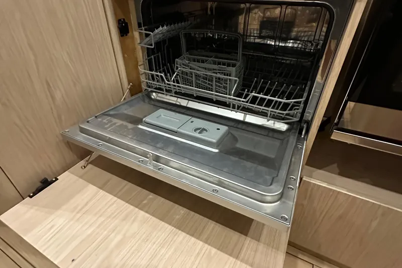 Slide: The Image of Open dishwasher in 2021 Beneteau Oceanis 55.1 yacht kitchen, showcasing modern interior design. - 46