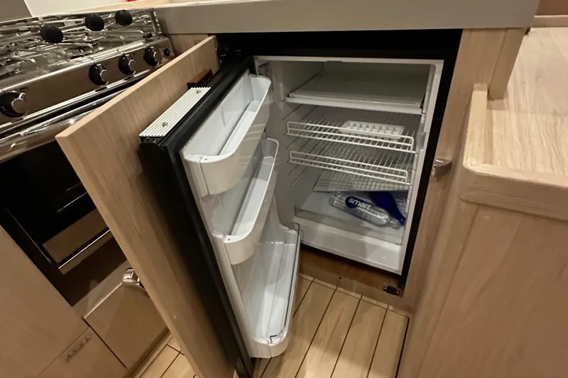 Slide: The Image of Beneteau Oceanis 55.1 yacht kitchen with open fridge, 2021 model. - 47