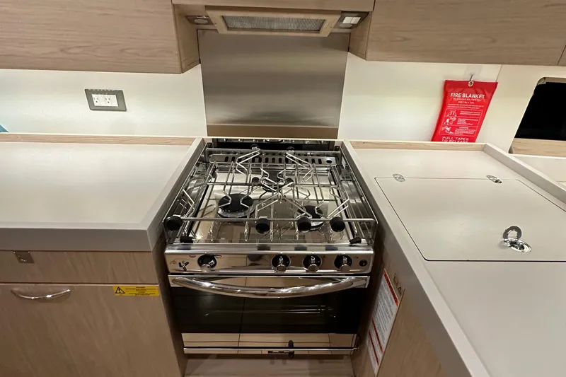 Slide: The Image of Modern kitchen in 2021 Beneteau Oceanis 55.1 yacht with stainless steel stove. - 50