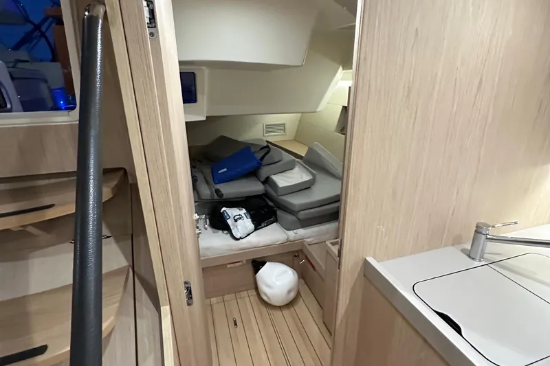Slide: The Image of Interior cabin of 2021 Beneteau Oceanis 55.1 yacht with cushions and storage. - 52