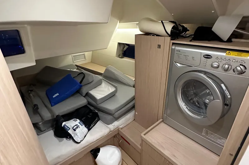 Slide: The Image of Interior of 2021 Beneteau Oceanis 55.1 yacht with washing machine and storage area. - 53