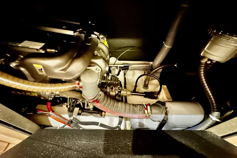 Slide: The Image of Engine compartment of a 2021 Beneteau Oceanis 55.1 sailboat, showcasing mechanical components. - 54