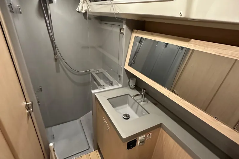 Slide: The Image of Modern bathroom in 2021 Beneteau Oceanis 55.1 yacht with shower and sink. - 59