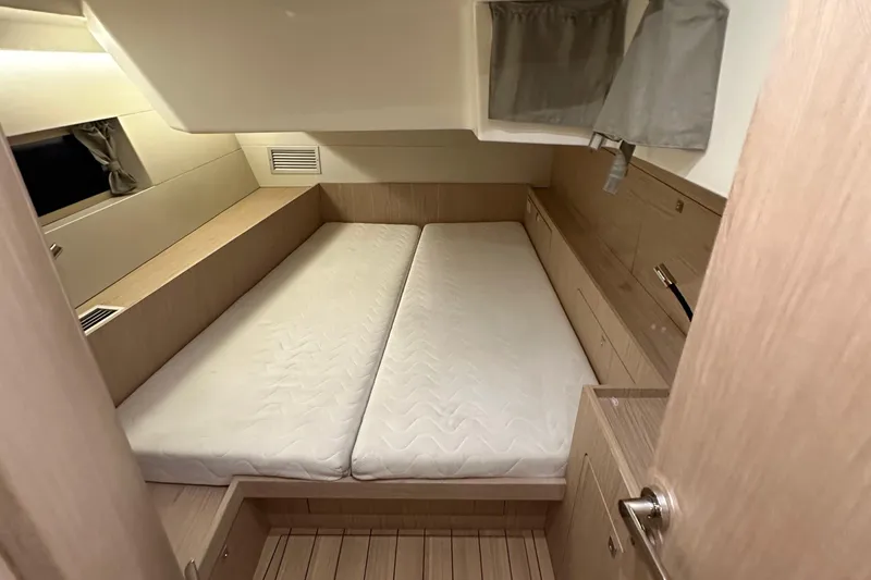 Slide: The Image of Interior cabin of 2021 Beneteau Oceanis 55.1 yacht with twin beds and wooden finish. - 60