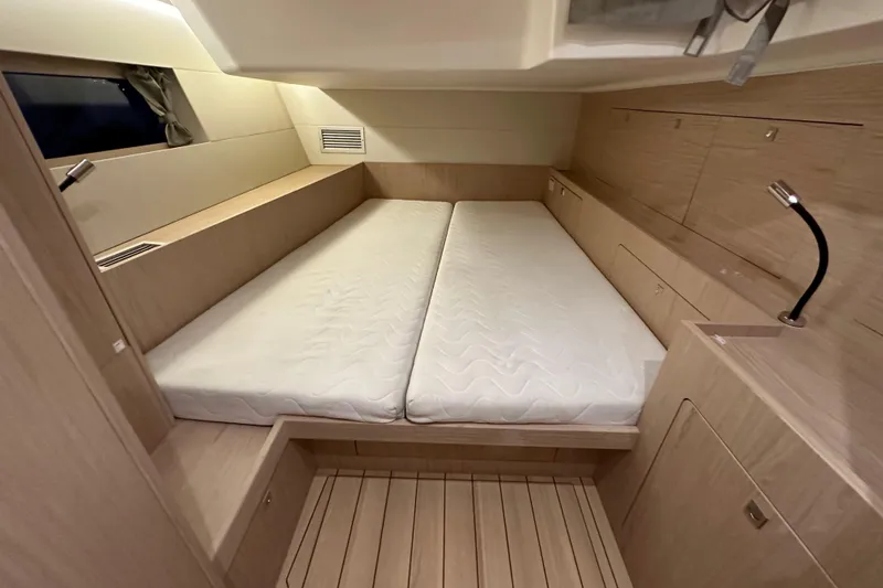 Slide: The Image of Modern cabin interior of 2021 Beneteau Oceanis 55.1 yacht with twin beds. - 61