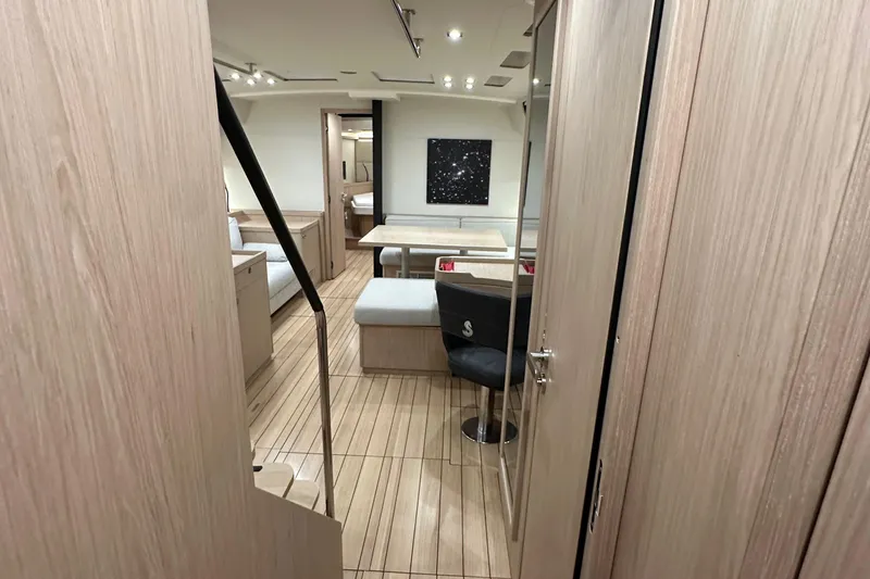 Slide: The Image of Luxurious interior of 2021 Beneteau Oceanis 55.1 yacht with modern furnishings and wood finish. - 62