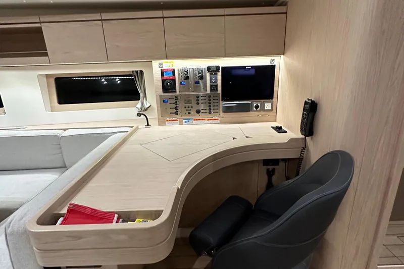 Slide: The Image of Interior of 2021 Beneteau Oceanis 55.1 yacht with navigation station and control panel. - 65