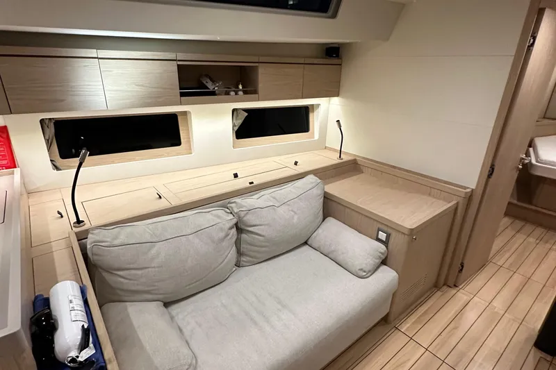 Slide: The Image of Modern interior of 2021 Beneteau Oceanis 55.1 yacht with cozy seating and wooden finishes. - 71