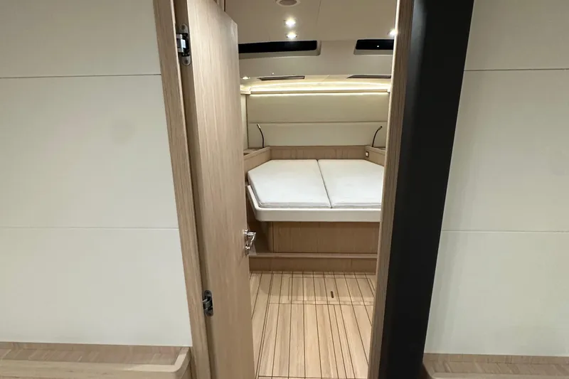 Slide: The Image of 2021 Beneteau Oceanis 55.1 yacht interior cabin with modern wood finish. - 75