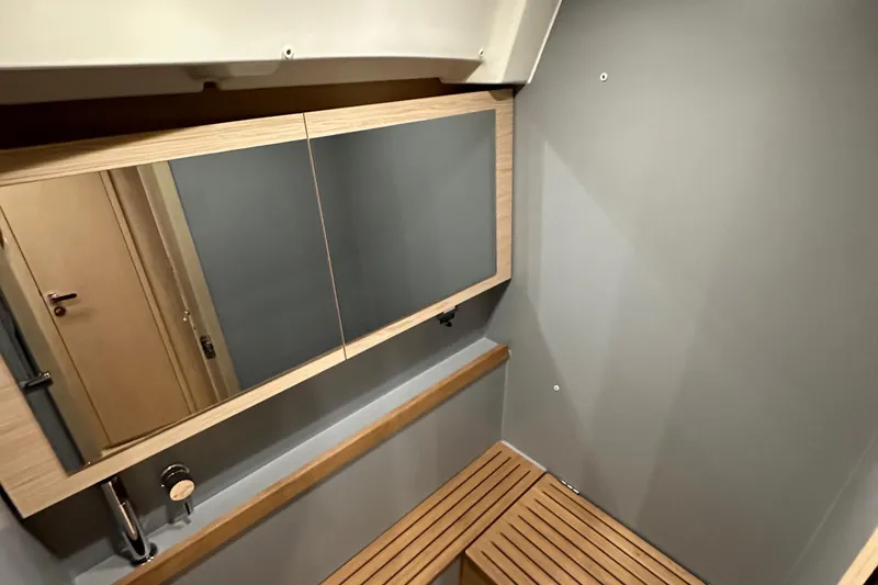 Slide: The Image of Modern bathroom interior of 2021 Beneteau Oceanis 55.1 yacht with wooden accents. - 79