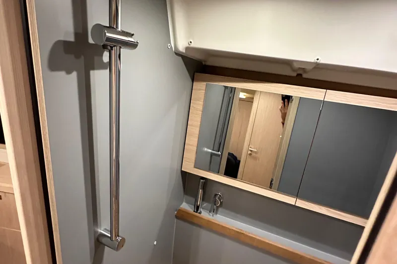 Slide: The Image of Bathroom interior of 2021 Beneteau Oceanis 55.1 yacht with mirror and shower. - 80