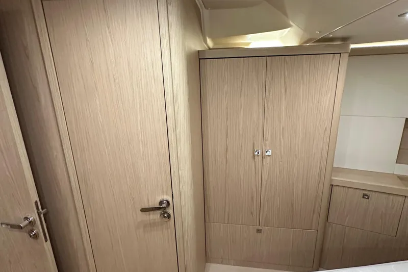 Slide: The Image of Interior of 2021 Beneteau Oceanis 55.1 yacht with light wood cabinetry and modern design. - 82