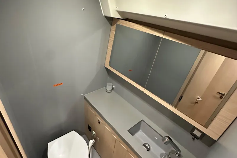 Slide: The Image of Bathroom interior of 2021 Beneteau Oceanis 55.1 yacht, featuring modern sink and mirror. - 83