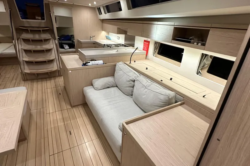 Slide: The Image of Luxurious interior of 2021 Beneteau Oceanis 55.1 yacht with modern kitchen and cozy seating. - 85