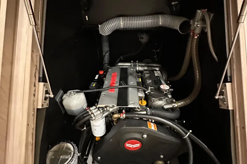 Slide: The Image of Engine compartment of a 2021 Beneteau Oceanis 55.1 sailboat, featuring a Yanmar engine. - 91