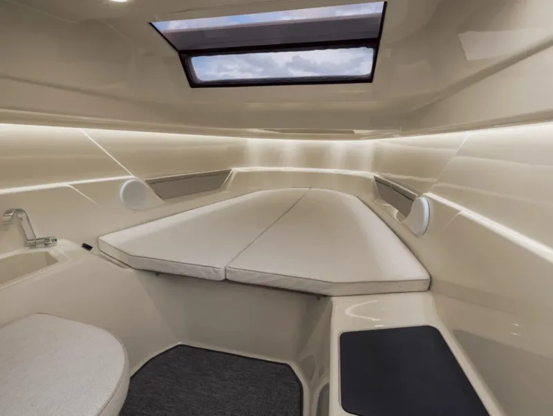 Slide: The Image of Luxurious interior cabin of 2025 Axopar AX/E 25 boat with skylight and seating. - 9