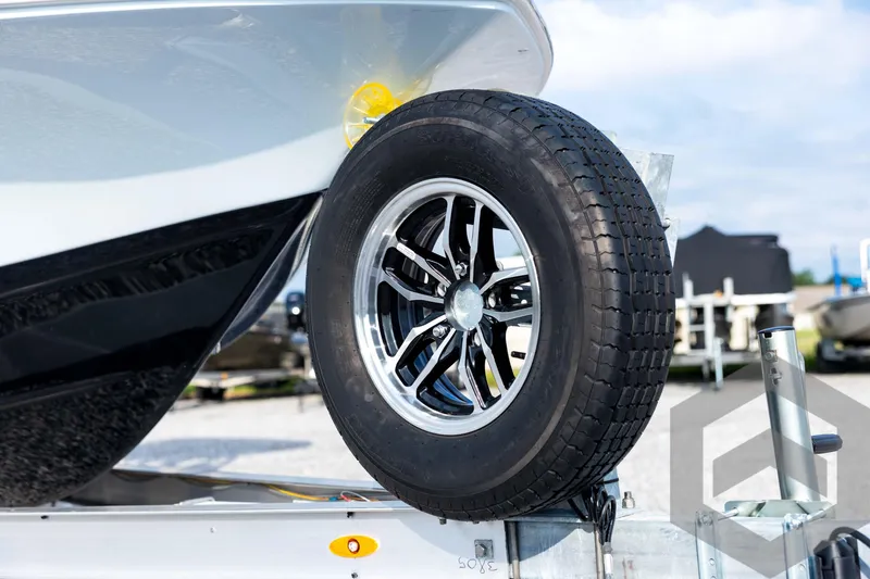 Slide: The Image of 2026 Tidewater 2410 Bay Max boat on trailer with black tire and chrome rim. - 10