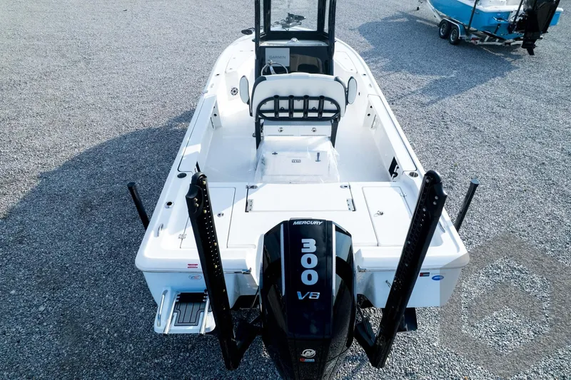 Slide: The Image of 2026 Tidewater 2410 Bay Max boat with Mercury 300 V8 engine, parked on gravel. - 101