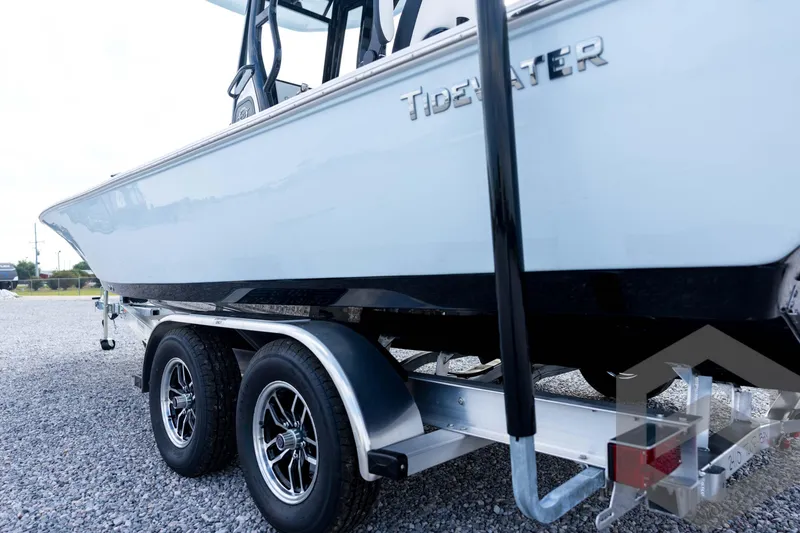 Slide: The Image of 2026 Tidewater 2410 Bay Max boat on trailer, side view, parked on gravel. - 26