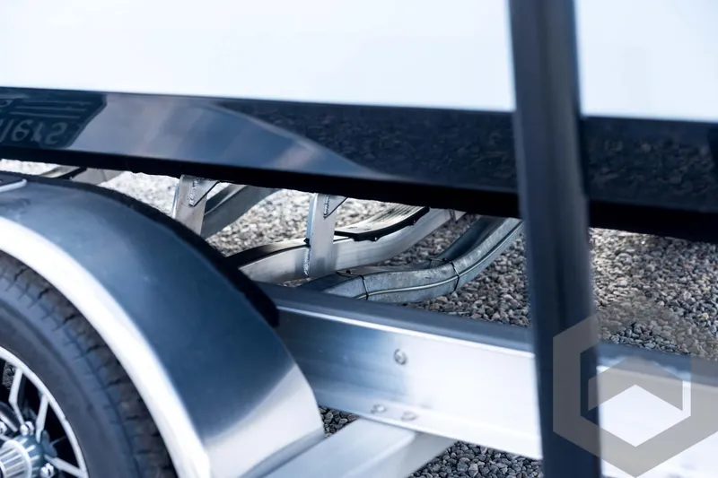 Slide: The Image of Trailer detail of 2026 Tidewater 2410 Bay Max boat on gravel surface. - 27