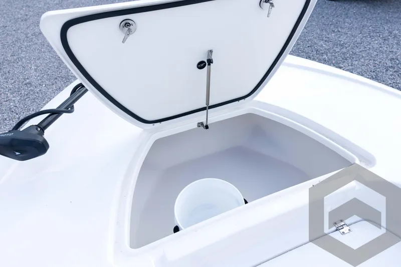 Slide: The Image of Open storage compartment on 2026 Tidewater 2410 Bay Max boat, featuring a white interior. - 39