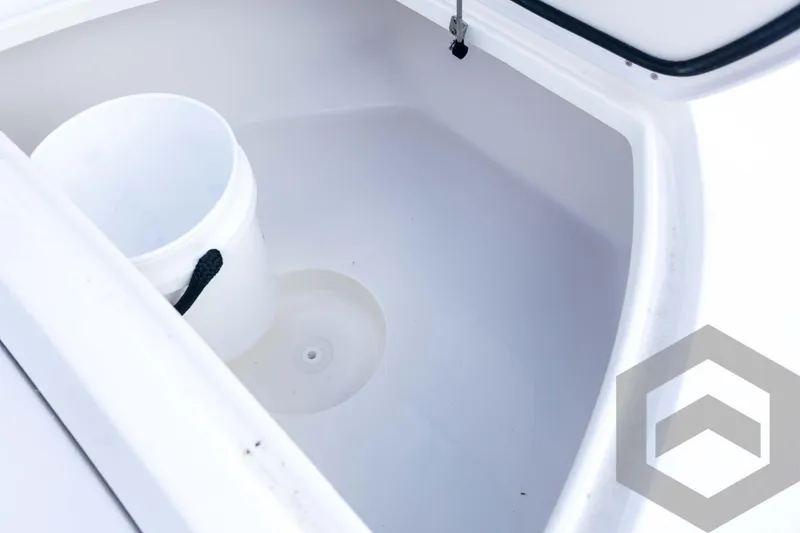 Slide: The Image of Storage compartment of 2026 Tidewater 2410 Bay Max boat with a white bucket. - 40