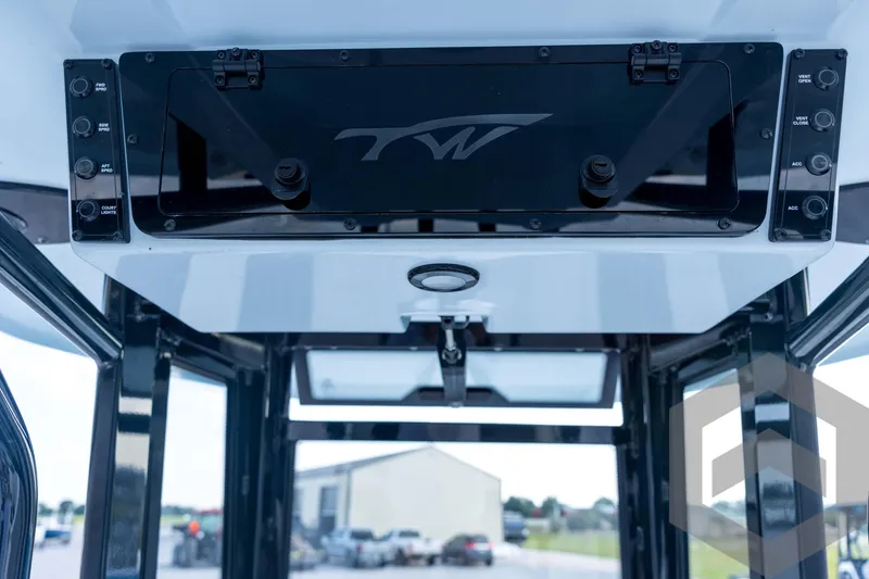 Slide: The Image of 2026 Tidewater 2410 Bay Max boat console with control panel and storage compartment. - 55