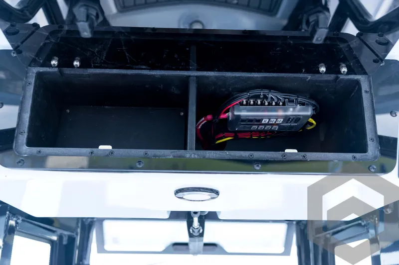 Slide: The Image of 2026 Tidewater 2410 Bay Max boat storage compartment with electrical components. - 59