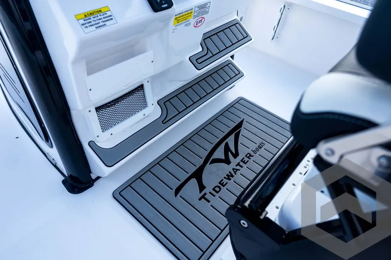 Slide: The Image of 2026 Tidewater 2410 Bay Max boat interior with branded mat and step details. - 66