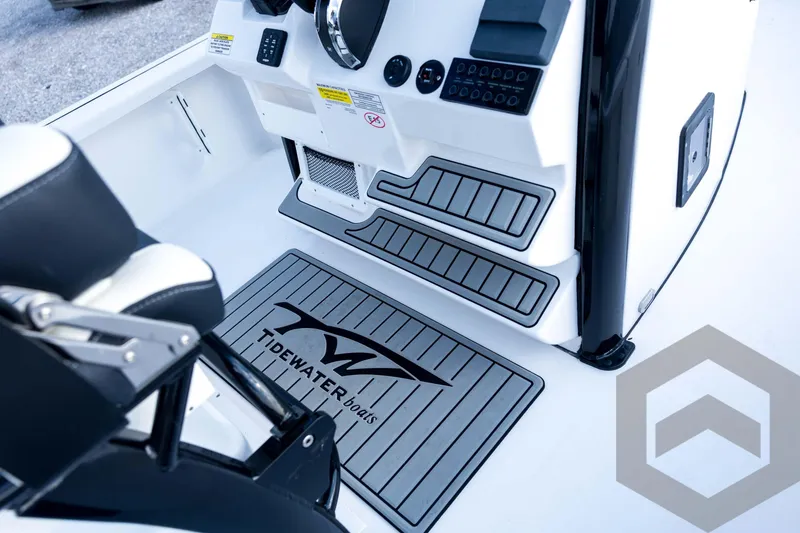 Slide: The Image of 2026 Tidewater 2410 Bay Max boat interior with branded mat and control panel. - 67