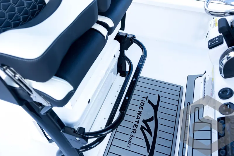 Slide: The Image of 2026 Tidewater 2410 Bay Max boat interior with seating and branded flooring. - 71