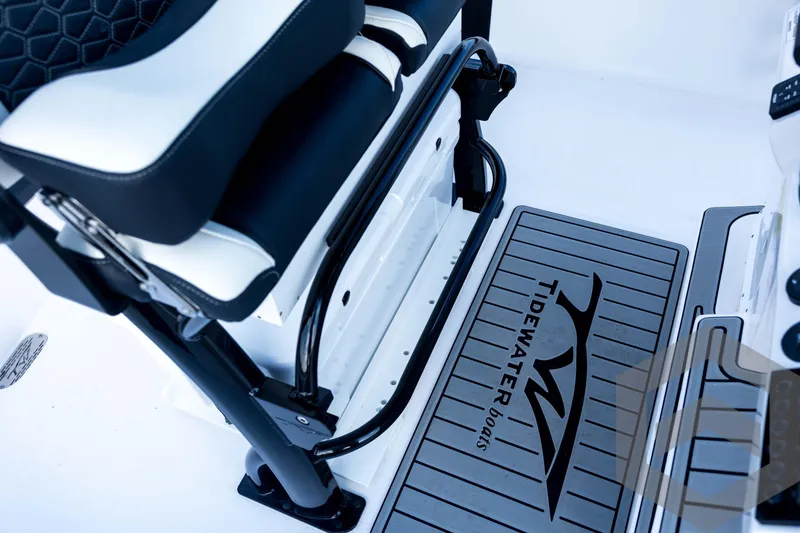 Slide: The Image of 2026 Tidewater 2410 Bay Max boat interior with branded flooring and seating. - 72