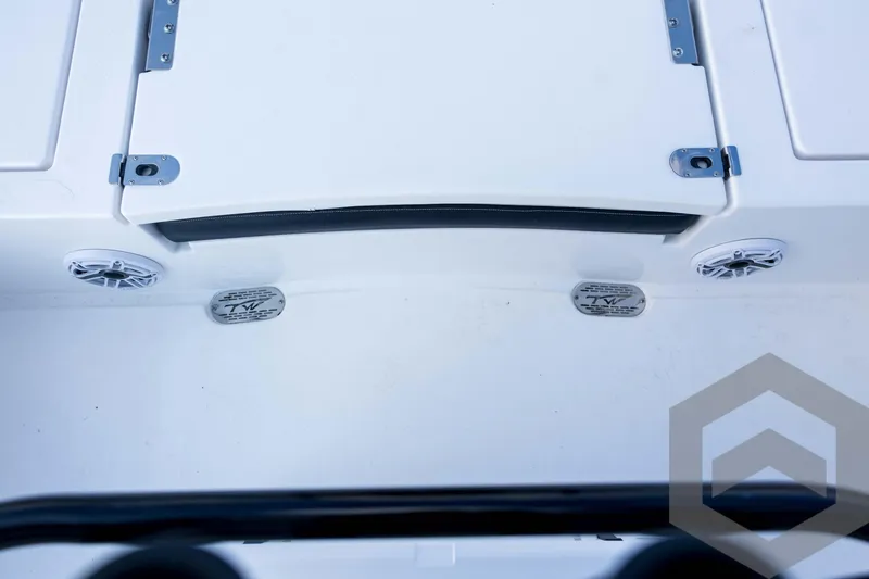 Slide: The Image of 2026 Tidewater 2410 Bay Max boat interior with speakers and storage compartment. - 79
