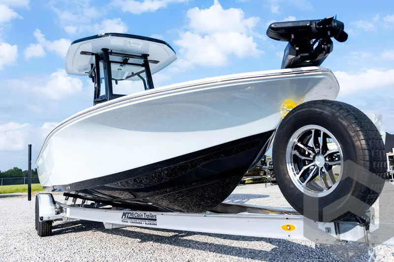 Slide: The Image of 2026 Tidewater 2410 Bay Max boat on trailer, under a clear blue sky. - 9