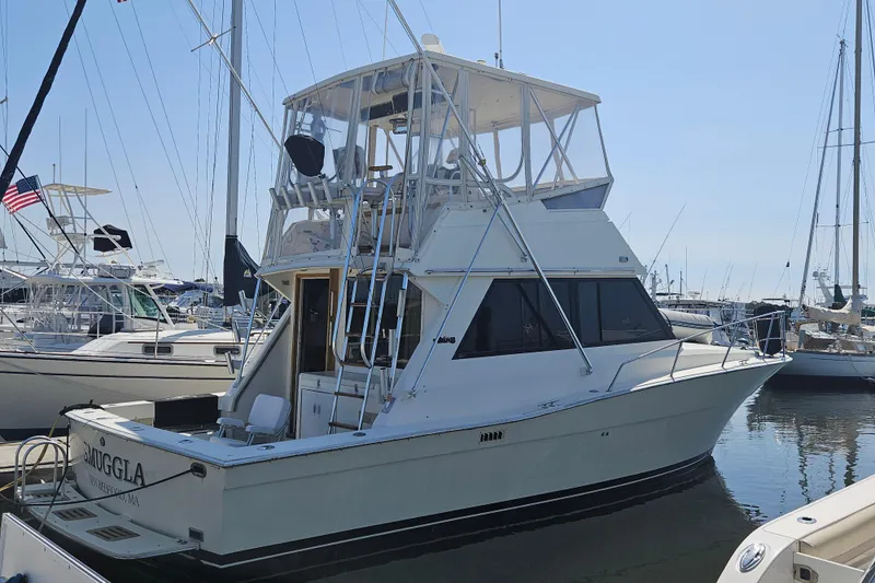 The Image of 1986 Viking 35 Convertible yacht docked in a marina, surrounded by other boats. - 0