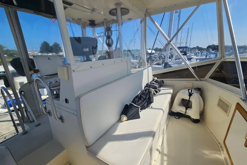 Slide: The Image of Interior view of a 1986 Viking 35 Convertible boat at a marina. - 2