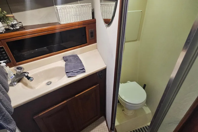 Slide: The Image of 1986 Viking 35 Convertible yacht bathroom with sink, toilet, and mirror. - 3