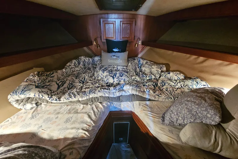 Slide: The Image of Cozy cabin interior of 1986 Viking 35 Convertible with nautical-themed bedding. - 8