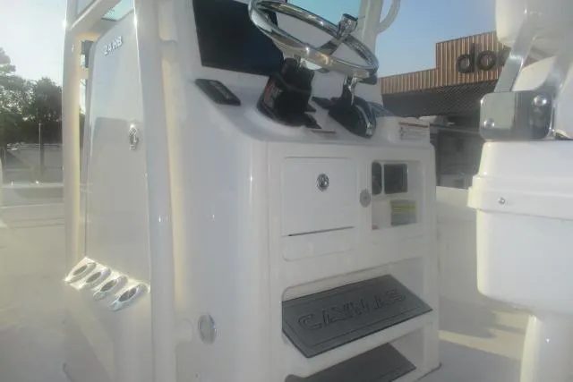 Slide: The Image of 2026 Caymas 24 HB boat console with steering wheel and controls. - 3